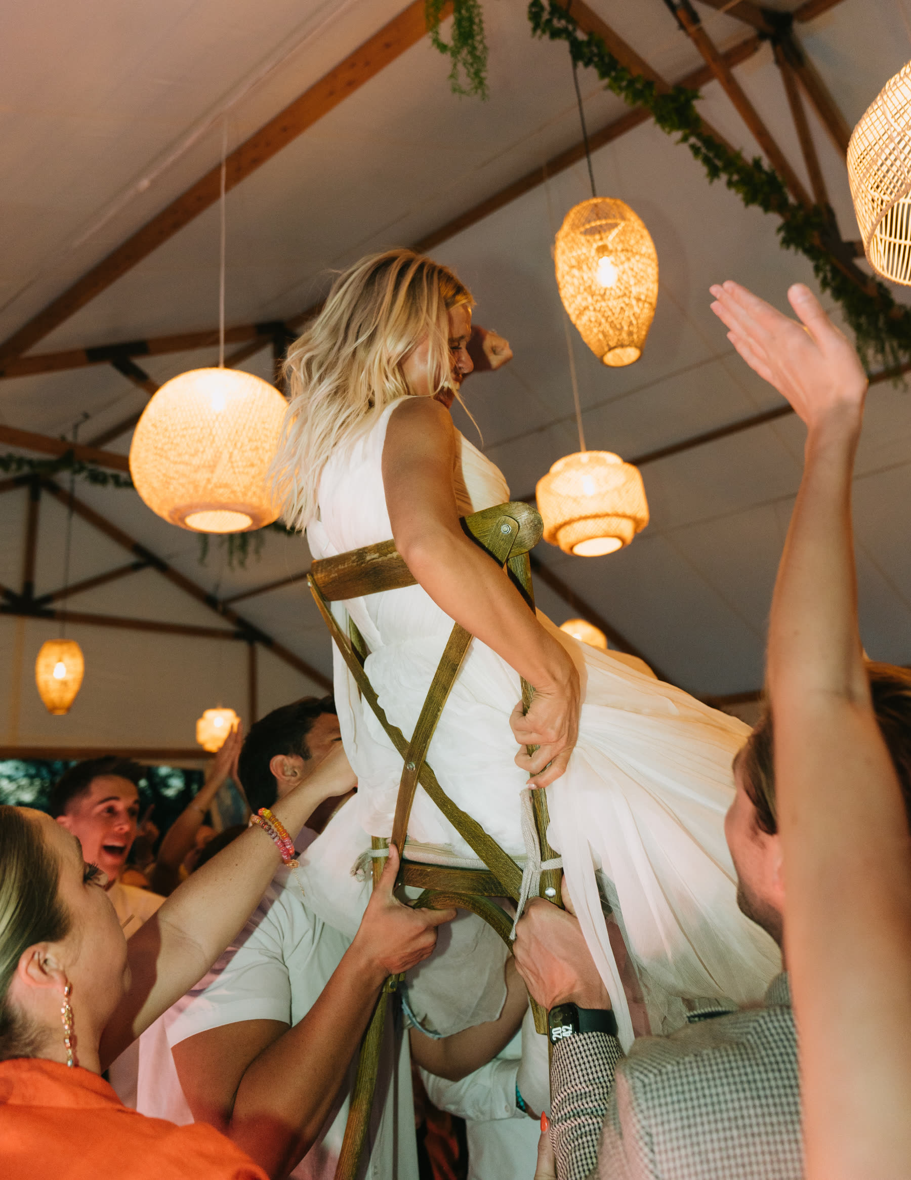 Bride lifted on a chair at the reception