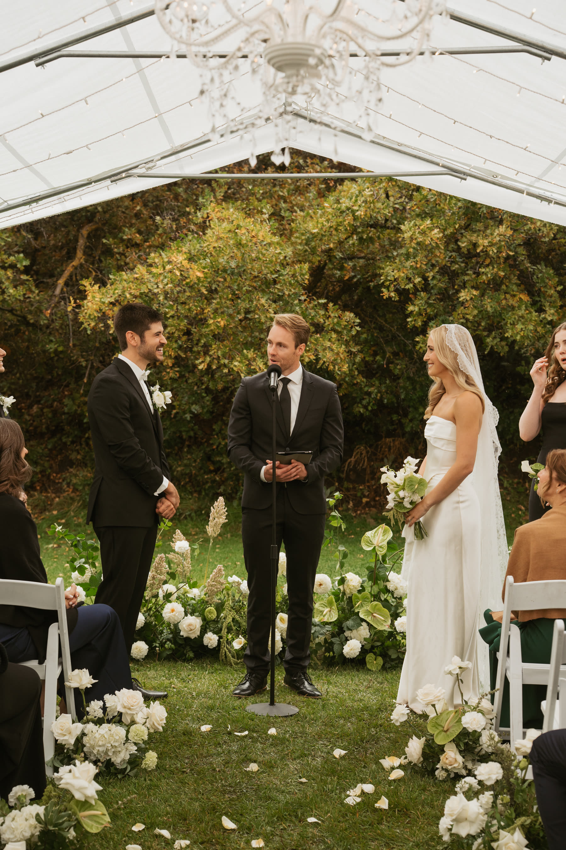 Outdoor wedding ceremony under a clear tent